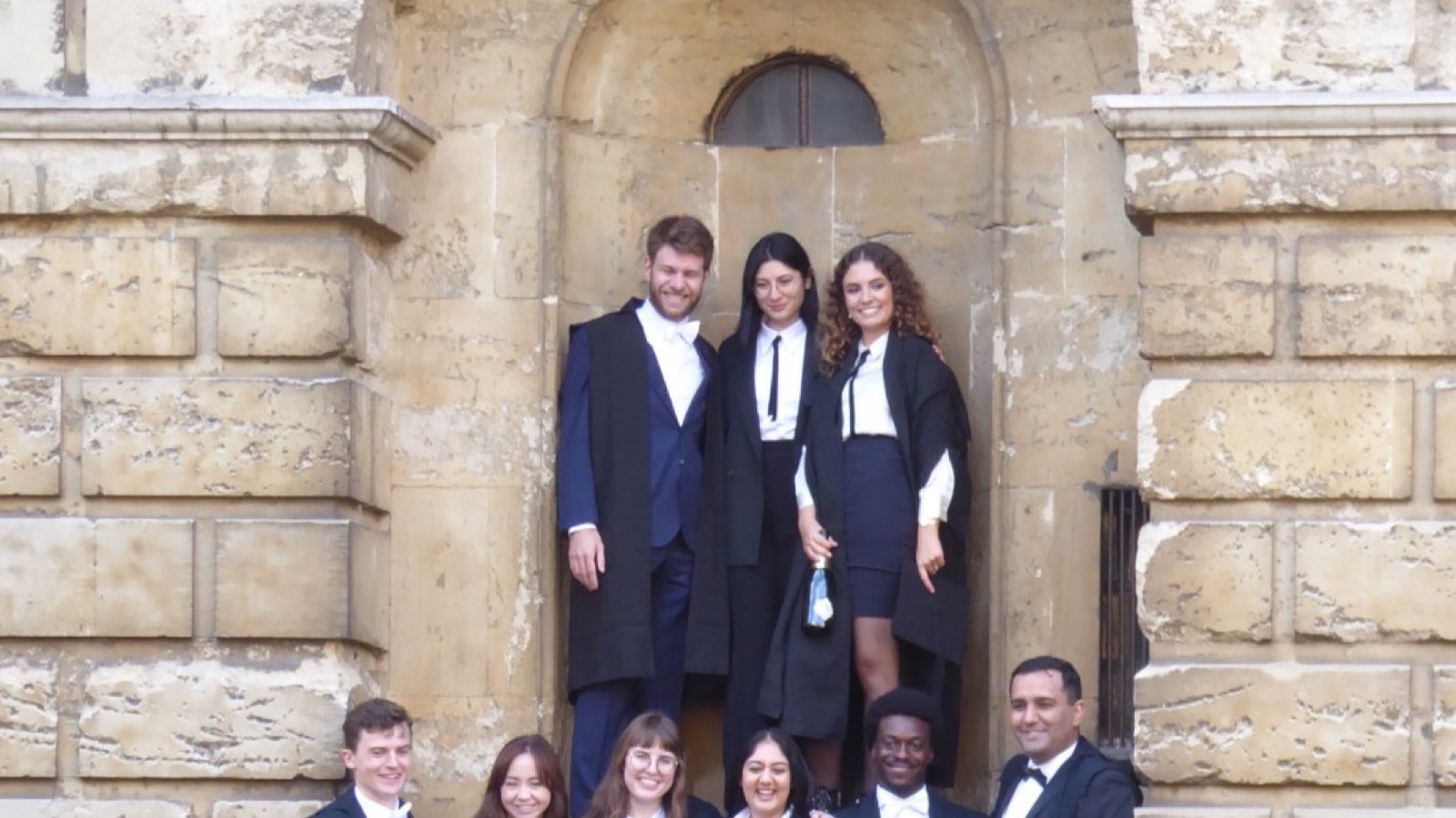 Oxford University students on Matriculation Day in front of a historic stone building