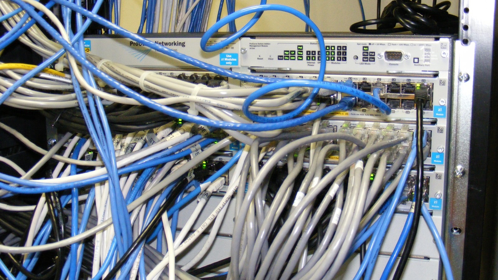 Rack-mounted network switch with many ethernet cables connected